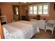 Comfortable bedroom features tiled floors, a large window, and a queen-sized bed at 423 Longfellow Blvd, Lakeland, FL 33801