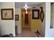 Hallway with framed photos leading to the bedrooms and bathrooms at 423 Longfellow Blvd, Lakeland, FL 33801
