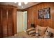 Living room with paneled walls, display cases, and a comfortable sofa at 423 Longfellow Blvd, Lakeland, FL 33801