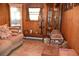 Living room with paneled walls, display cases, and a comfortable sofa at 423 Longfellow Blvd, Lakeland, FL 33801