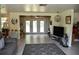 Open living room with tv, desk and exterior access with french doors at 423 Longfellow Blvd, Lakeland, FL 33801