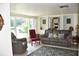 Cozy living room with a large rug, and a large window for natural light at 423 Longfellow Blvd, Lakeland, FL 33801
