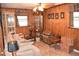 Living room with paneled walls, display cases, and a comfortable sofa at 423 Longfellow Blvd, Lakeland, FL 33801