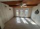 Bright sunroom with wood-paneled walls and tiled floor at 423 Longfellow Blvd, Lakeland, FL 33801