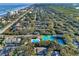 Community overview showing homes, pool, and tennis courts near the beach at 4411 Sea Mist Ct # 174, New Smyrna Beach, FL 32169