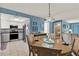 Dining area with a round table and four chairs, open to kitchen at 4411 Sea Mist Ct # 174, New Smyrna Beach, FL 32169