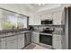 Kitchen with stainless steel appliances and gray countertops at 4411 Sea Mist Ct # 174, New Smyrna Beach, FL 32169