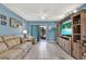 Bright living room with comfy seating, large TV, and built-in shelving at 4411 Sea Mist Ct # 174, New Smyrna Beach, FL 32169