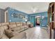 Living room with sectional sofa, tiled floor, and access to a patio at 4411 Sea Mist Ct # 174, New Smyrna Beach, FL 32169