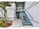 Exterior condo staircase leading to second floor, with bikes parked nearby at 4411 Sea Mist Ct # 174, New Smyrna Beach, FL 32169