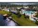 An aerial view of a lakefront community featuring a pool, clubhouse, and recreational facilities at 4800 Memories Ln, Kissimmee, FL 34746