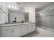 Bright bathroom with a double sink vanity and a glass-enclosed shower/tub combination at 4800 Memories Ln, Kissimmee, FL 34746
