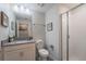 Well-lit bathroom with neutral colors, single vanity and a standing shower at 4800 Memories Ln, Kissimmee, FL 34746
