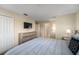 Bedroom featuring neutral colors, a comfy bed, dresser and a television at 4800 Memories Ln, Kissimmee, FL 34746
