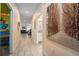 Hallway with neutral walls, tile floors, and artwork leading to various rooms in the house at 4800 Memories Ln, Kissimmee, FL 34746