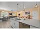Open-concept kitchen with stainless appliances, white cabinets, quartz countertops, and view to dining area at 4800 Memories Ln, Kissimmee, FL 34746
