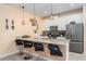 Modern kitchen featuring stainless steel appliances, a breakfast bar, and stylish pendant lighting at 4800 Memories Ln, Kissimmee, FL 34746