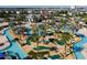 Aerial view of community's lazy river, miniature golf, and tropical landscaping create a resort-like atmosphere at 4800 Memories Ln, Kissimmee, FL 34746