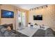 Comfortable living room with decorative wall, large TV, and sliding door to the outdoor space at 4800 Memories Ln, Kissimmee, FL 34746