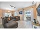 Living room with a grey sectional sofa, tile floors, and sliding glass door to the pool area at 4800 Memories Ln, Kissimmee, FL 34746