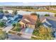 Aerial view of the home with a two-car garage, landscaping and a view of the neighborhood lake at 4912 Atwood Dr, Orlando, FL 32828