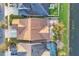 An overhead aerial view reveals the brick-paved patio in the backyard with mature trees and a neighborhood lake at 4912 Atwood Dr, Orlando, FL 32828
