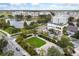Aerial view of a mixed-use community with apartments, shops, and a serene lake with a fountain at 4912 Atwood Dr, Orlando, FL 32828