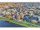 A view of the back of the home with proximity to the neighborhood lake from this aerial view at 4912 Atwood Dr, Orlando, FL 32828