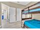 This bedroom features a bunk bed, closet, and connects to a blue-walled bathroom at 4912 Atwood Dr, Orlando, FL 32828