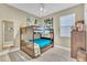 This cozy bedroom boasts a bunk bed, a ceiling fan, and bright natural light from the window at 4912 Atwood Dr, Orlando, FL 32828
