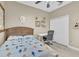 Bedroom features a comfortable bed, ceiling fan, and functional workspace with a closet at 4912 Atwood Dr, Orlando, FL 32828