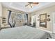 Relaxing bedroom with a wooden bed, view of the water, sitting area, and ensuite bathroom at 4912 Atwood Dr, Orlando, FL 32828