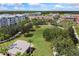 Aerial view of a common green area with walking paths bordered by colorful townhomes at 4912 Atwood Dr, Orlando, FL 32828