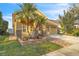 Well-maintained home featuring a two-car garage, manicured lawn, and vibrant tropical landscaping at 4912 Atwood Dr, Orlando, FL 32828