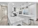 Contemporary white kitchen with an expansive marble island and stainless steel appliances at 4912 Atwood Dr, Orlando, FL 32828