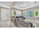 Bright living room with tile floors, modern leaf art, and comfortable leather seating at 4912 Atwood Dr, Orlando, FL 32828
