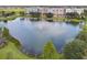 Scenic view of a neighborhood pond featuring a fountain, framed by manicured green spaces at 4912 Atwood Dr, Orlando, FL 32828