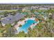 Aerial shot of a resort-style community pool, jacuzzi and well-maintained grounds with lush palm trees at 4912 Atwood Dr, Orlando, FL 32828