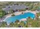 Aerial view of a resort-style community pool with lush landscaping and a large clubhouse at 4912 Atwood Dr, Orlando, FL 32828
