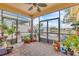 Screened-in porch featuring brick floors, potted plants, and tranquil views of the lake at 4912 Atwood Dr, Orlando, FL 32828