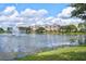 Scenic lake view with fountain and colorful condos in the distance, perfect for relaxing at 4912 Atwood Dr, Orlando, FL 32828
