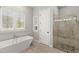 Modern bathroom with a walk-in shower and free-standing tub at 506 Yellow Submarine Ct, Groveland, FL 34737