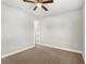 Simple bedroom with ceiling fan and carpet flooring at 506 Yellow Submarine Ct, Groveland, FL 34737