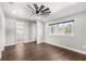 Bright bedroom with wood floors, ceiling fan, and access to bathroom at 506 Yellow Submarine Ct, Groveland, FL 34737