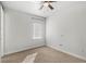Simple bedroom with ceiling fan and window with blinds at 506 Yellow Submarine Ct, Groveland, FL 34737
