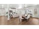Elegant dining room with hardwood floors and large windows at 506 Yellow Submarine Ct, Groveland, FL 34737