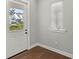 Bright entryway with hardwood floors and a view to the exterior at 506 Yellow Submarine Ct, Groveland, FL 34737