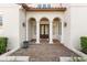 Elegant entry with arched columns, tile accents, and a double door at 506 Yellow Submarine Ct, Groveland, FL 34737