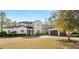 Two-story house with tile roof, large windows, and a three-car garage at 506 Yellow Submarine Ct, Groveland, FL 34737