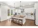 Bright kitchen featuring a wood-topped island with seating, stainless steel appliances, and modern pendant lighting at 506 Yellow Submarine Ct, Groveland, FL 34737